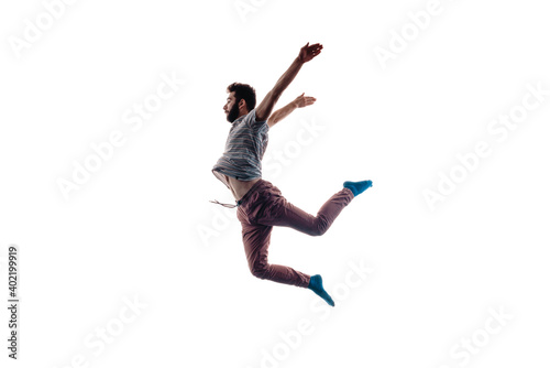 Young dance artist whiel jumping on white wall
