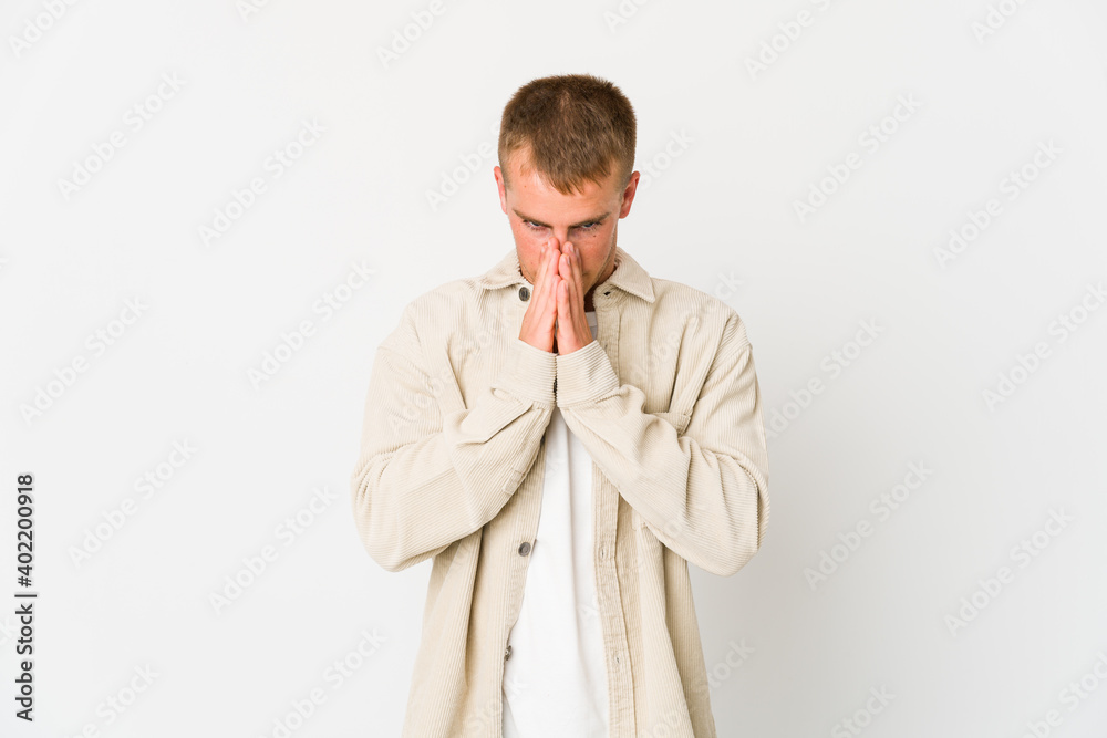 Young caucasian handsome man praying, showing devotion, religious person looking for divine inspiration. Young caucasian handsome man praying, showing devotion, religious person looking for divine inspiration.