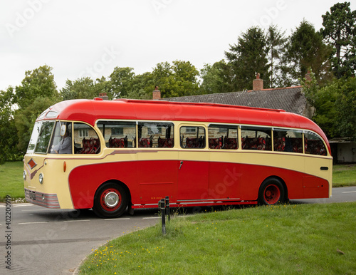 Vintage single deck red bus on the street in the Cotswolds