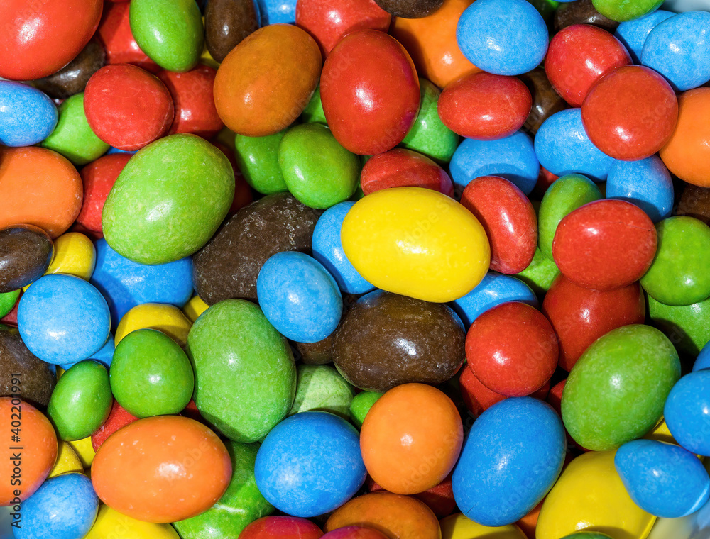 A series of multi-colored button-shaped chocolates A series of multi-colored button-shaped chocolates