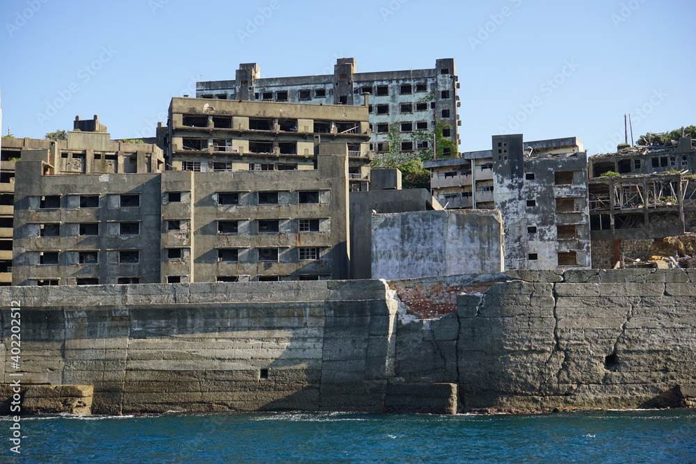 Abandoned Industrial houses and buildings of Gunkanjima or Battleship island, Ghost Island, from ferry boat in Nagasaki, Japan - 長崎 軍艦島