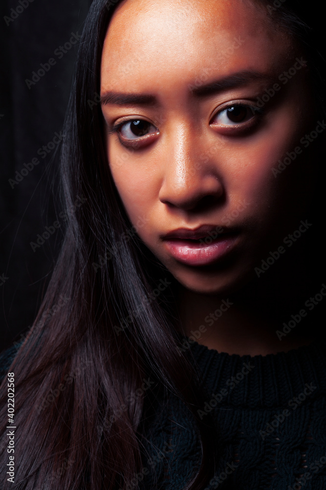pretty young asian girl posing sensitive on black background, lifestyle people concept