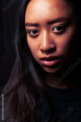 pretty young asian girl posing sensitive on black background  lifestyle people concept