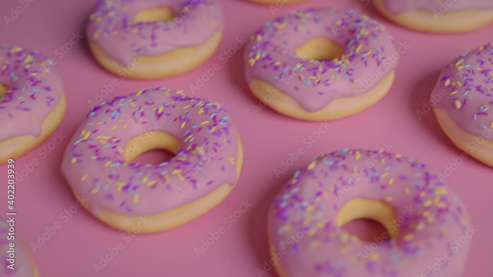 Pink frosting donuts on a pink background