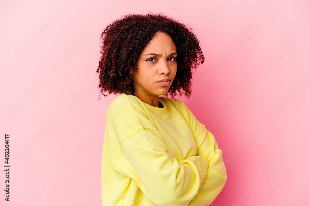 Young african american mixed race woman isolated frowning face in displeasure, keeps arms folded. Young african american mixed race woman isolated frowning face in displeasure, keeps arms folded.
