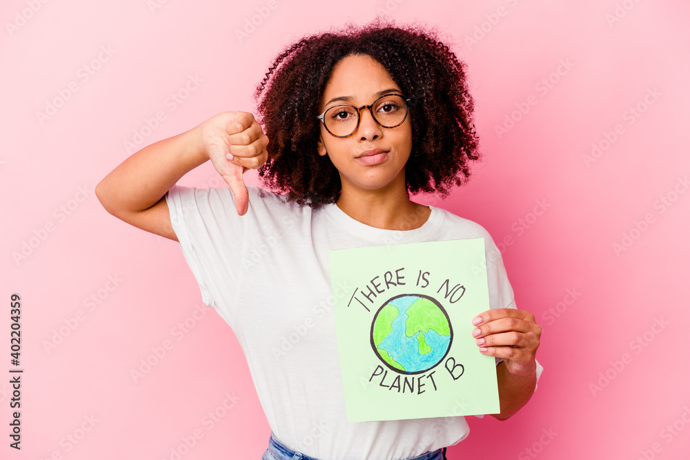 Young african american mixed race woman holding a world protection concept cardboard showing a dislike gesture, thumbs down. Disagreement concept. Young african american mixed race woman holding a world protection concept cardboard showing a dislike gesture, thumbs down. Disagreement concept.