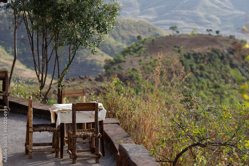 Fototapeta premium a table with chairs placed on the track to open a beautiful view of the landscape