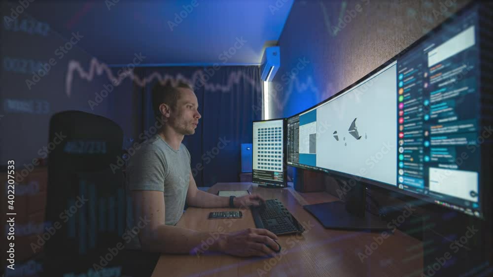 The engineer working on widescreen computer behind holographic layer