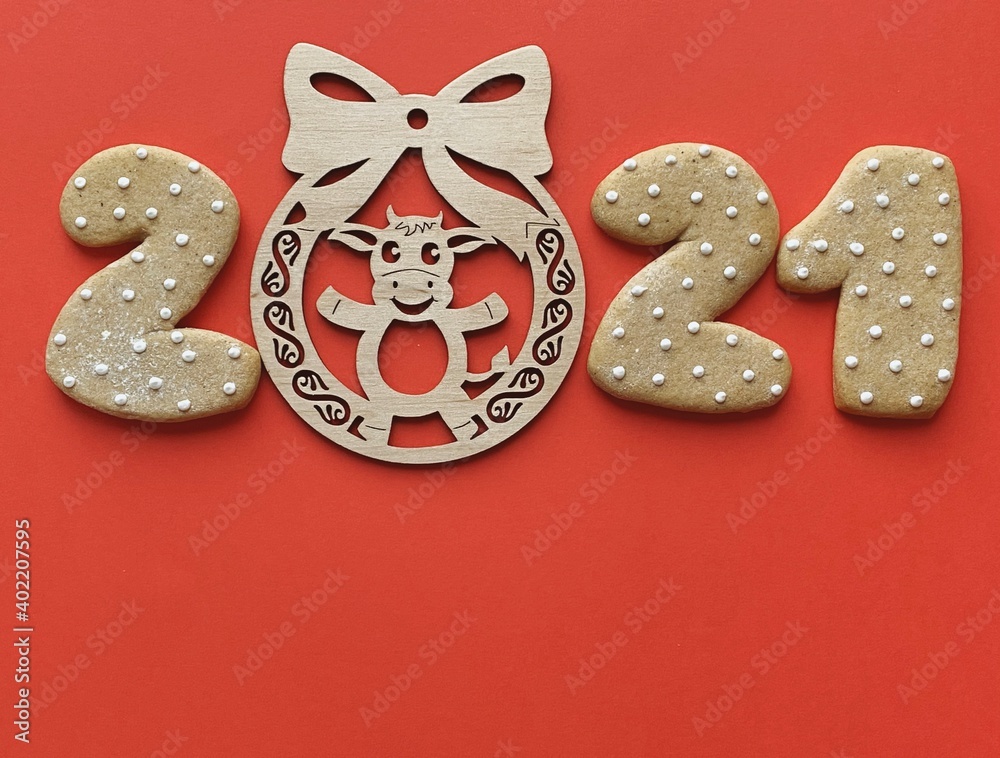Ox year 2021 wooden toy on red background Ox year 2021 wooden toy on red background