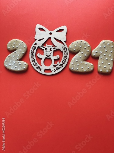 Ox year 2021 wooden toy on red background 