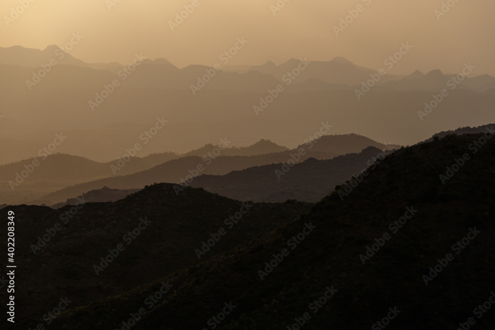 the Ethiopian valley at sunset turns so very yellow and forms mountain landscape silhouettes