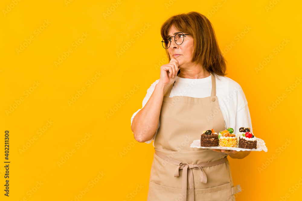 Middle age caucasian cook woman looking sideways with doubtful and skeptical expression. Middle age caucasian cook woman looking sideways with doubtful and skeptical expression.