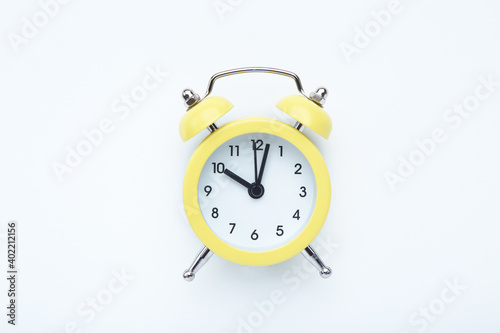 Yellow alarm clock on white background