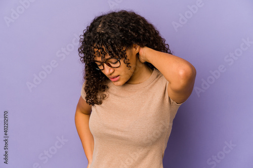 Young african american afro woman isolated having a neck pain due to stress, massaging and touching it with hand.