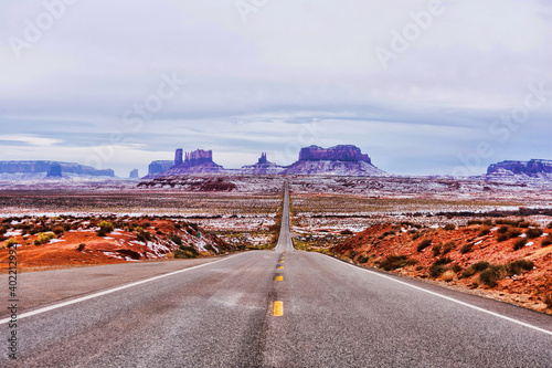 Highway 163 leading to the towering sandstone buttes and mesas of the Monument Valley Navajo Tribal Park on winter overcast day