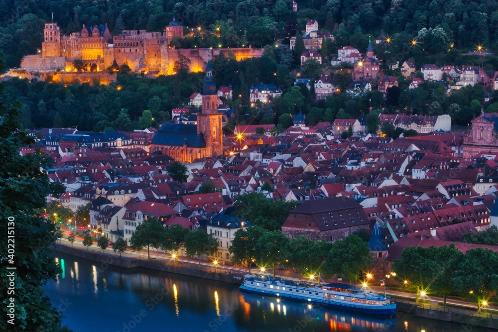 Night time view over the rooftops of the Old Town of Heidelberg, Germany and the Neckar River