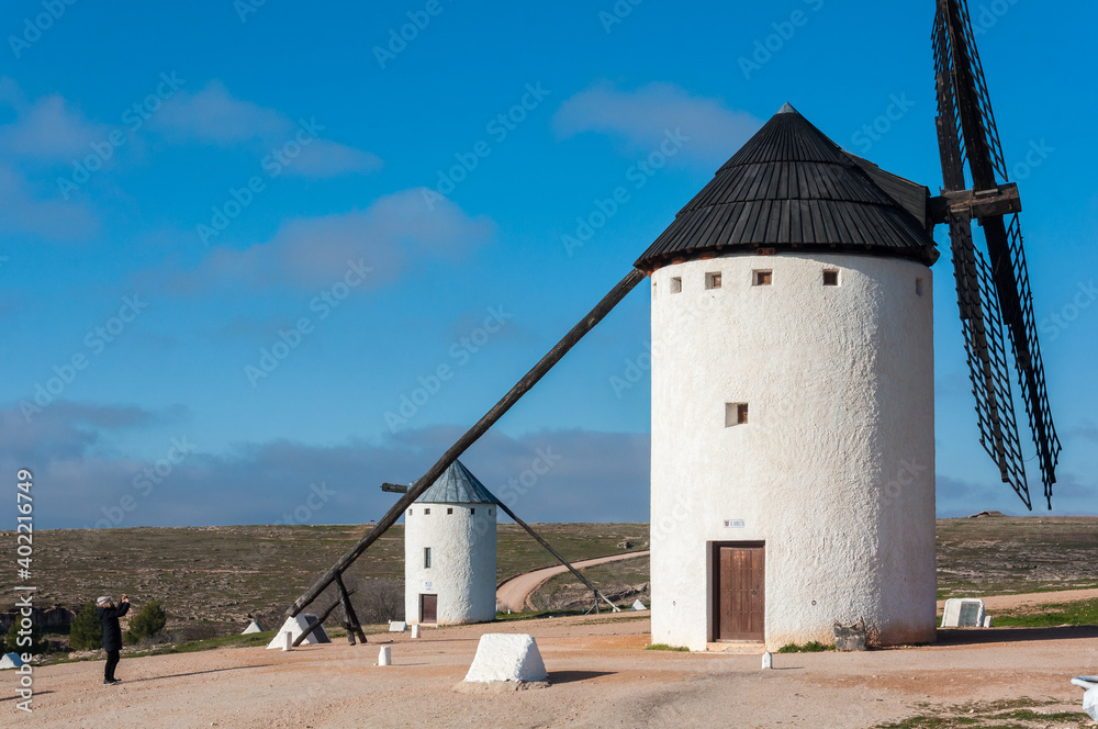 Tourist visiting windmills in Campo de Criptana, Castile La Mancha, Spain