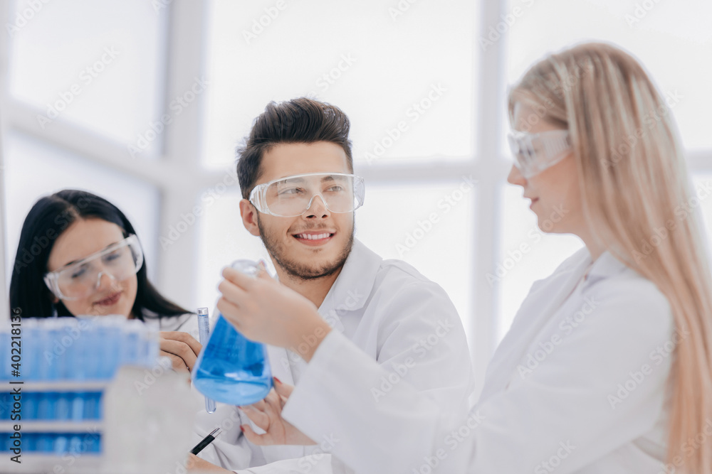 close up.a team of scientists sitting at the laboratory table close up.a team of scientists sitting at the laboratory table