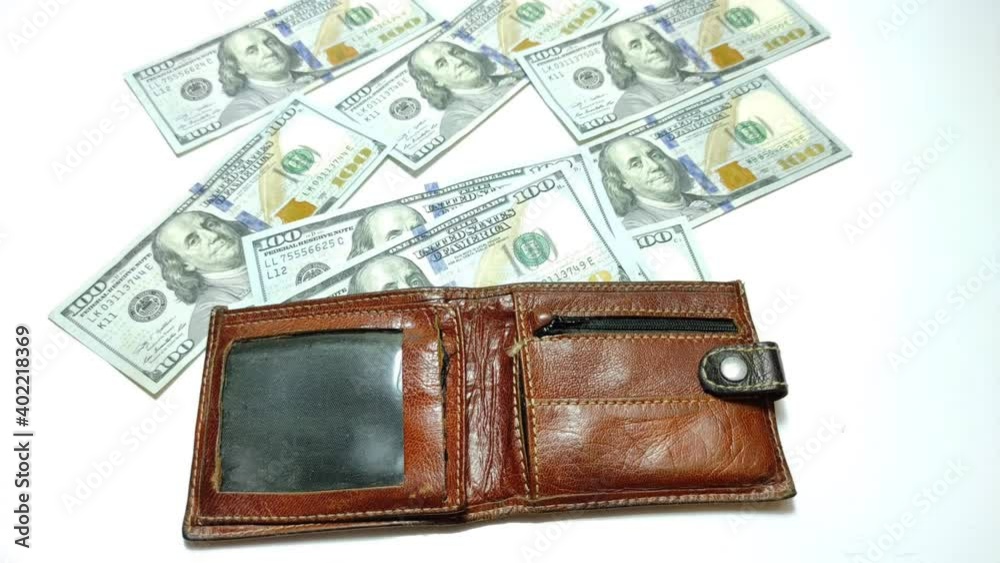 Hundred dollar bills are folded into a wallet. Stop motion animation. Hundred dollar bills are folded into a wallet. Stop motion animation.