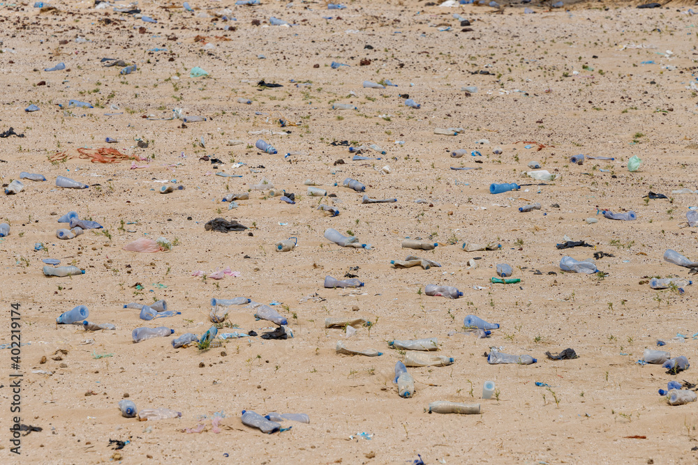 in the desert tossed in the sand a lot of plastic bottles and other waste in the desert tossed in the sand a lot of plastic bottles and other waste