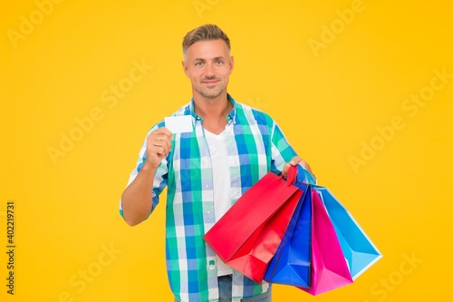 shopaholic. christmas sales and discounts. birthday present packs. guy with credit card. happy man carry shopping bags. black friday. shopper with packages. prepare for holidays. Choosing the best