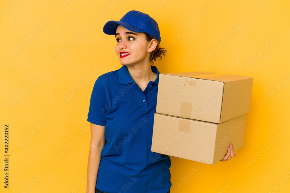 Young skinny delivery arab girl looks aside smiling, cheerful and pleasant. Young skinny delivery arab girl looks aside smiling, cheerful and pleasant.