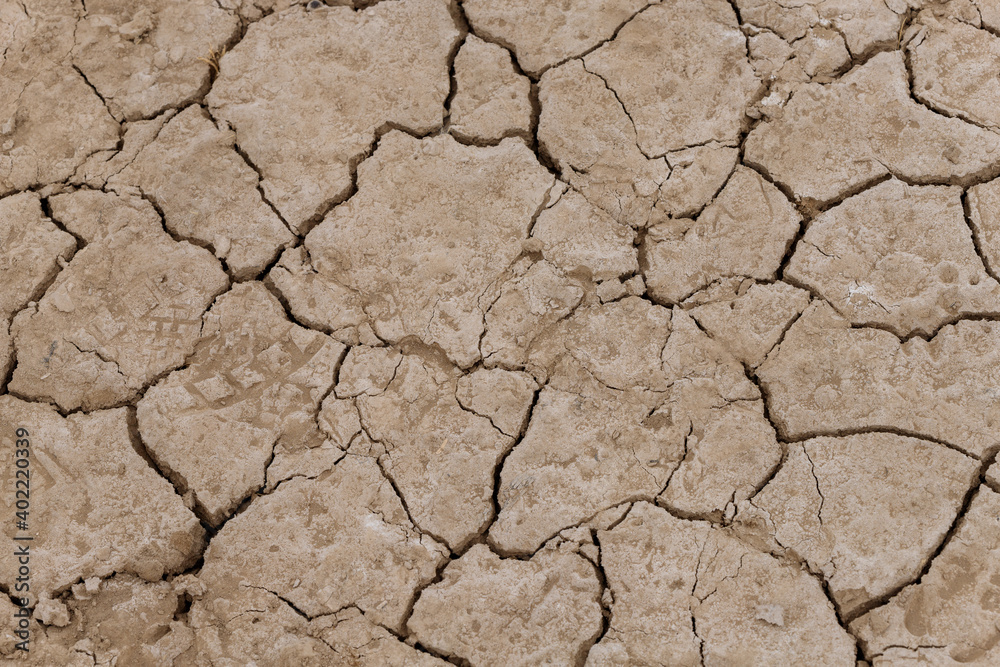 top view of a dried-up riverbed in southern Ethiopia where the ground is cracked and grass is trying to grow top view of a dried-up riverbed in southern Ethiopia where the ground is cracked and grass is trying to grow