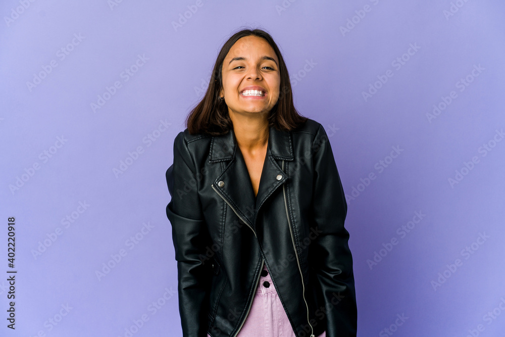 Young mixed race woman laughs and closes eyes, feels relaxed and happy. Young mixed race woman laughs and closes eyes, feels relaxed and happy.