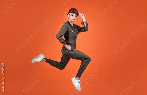 woman in boiler suit and helmet jump. umping builder hurry up on work. building and construction concept. sale on service. lady worker running. full of energy. stamina. fast and quality service