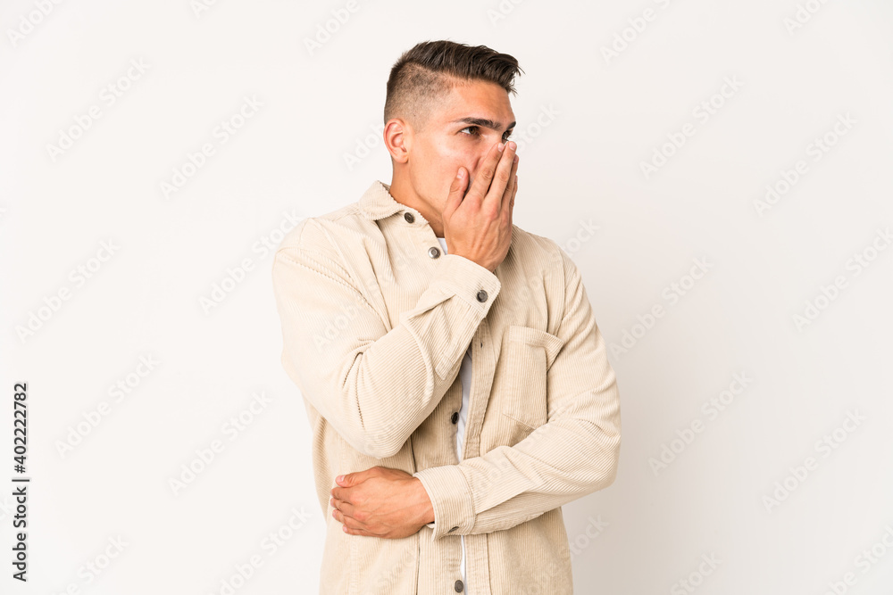 Young caucasian handsome man isolated yawning showing a tired gesture covering mouth with hand. Young caucasian handsome man isolated yawning showing a tired gesture covering mouth with hand.