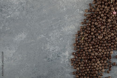 Chocolate sprinkles on a stone background