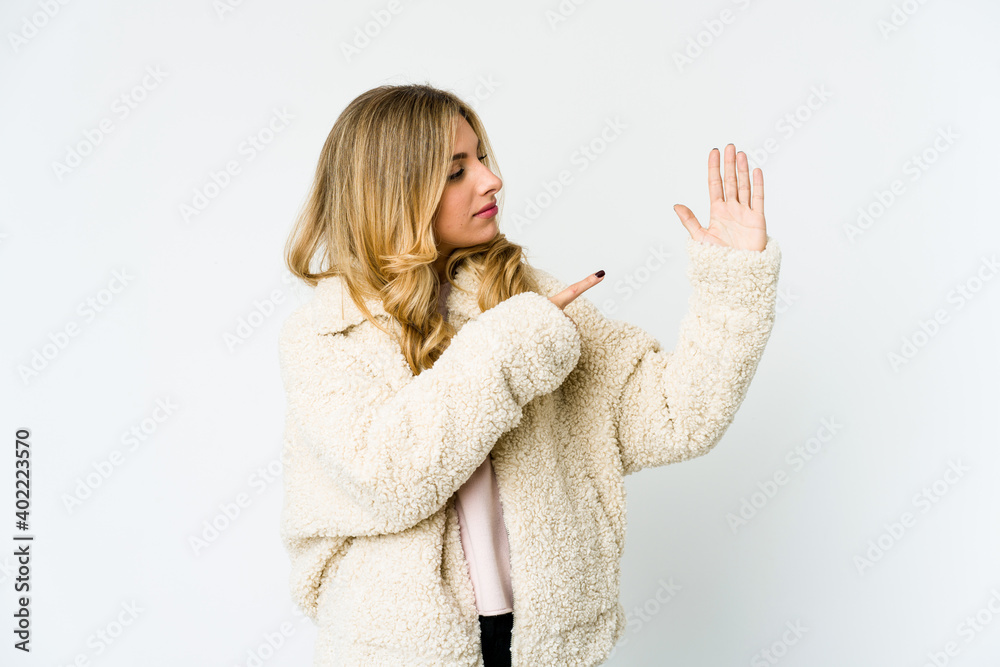 Young caucasian blonde woman smiling cheerful showing number five with fingers. Young caucasian blonde woman smiling cheerful showing number five with fingers.