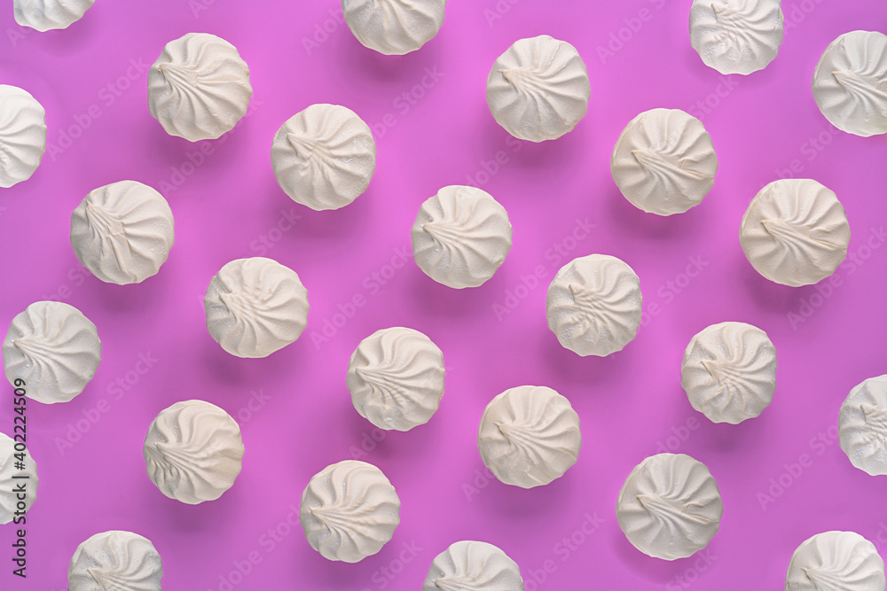 white sweet fluffy marshmallows pattern on pink background.wallpaper.top view.close up.copy space.candy.colorful dessert. white sweet fluffy marshmallows pattern on pink background.wallpaper.top view.close up.copy space.candy.colorful dessert.
