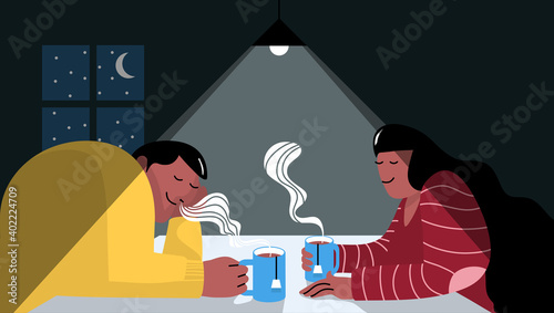 Couple drinking tea under the kitchen lamp at home with window and moon in the background. Romantic time concept.