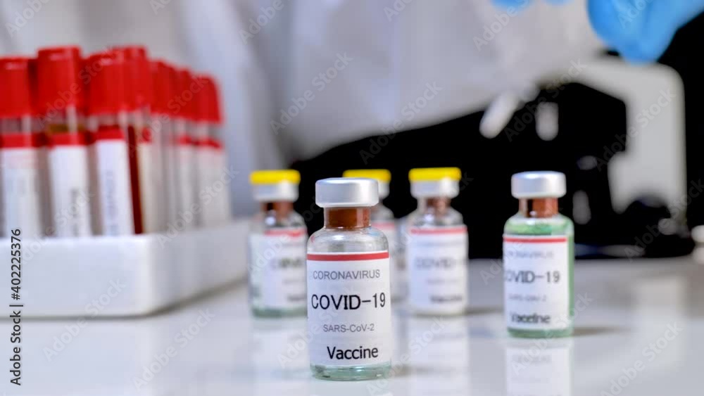 Concept fight against virus covid-19 coronavirus, doctor or scientist in laboratory holding a syringe with liquid vaccines for children or older adults, Concept: diseases, medical care, slow-motion. Concept fight against virus covid-19 coronavirus, doctor or scientist in laboratory holding a syringe with liquid vaccines for children or older adults, Concept: diseases, medical care, slow-motion.