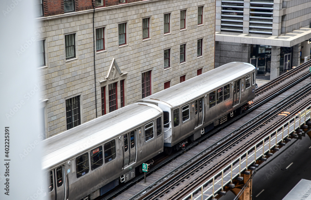Naklejka premium High angle view of vintage commuter train and tracks in among the city skyscrapers