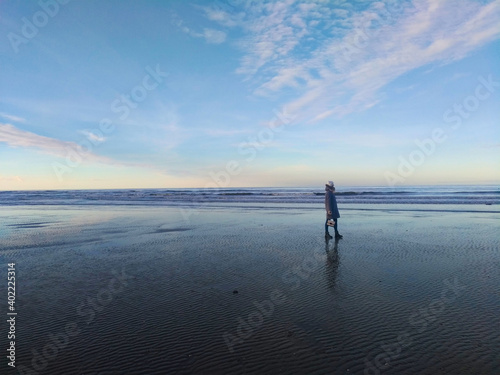 Girl on the background of the sea and blue sky coast of the English Channel in France in the city of Deauville. Travel across France. Woman traveler