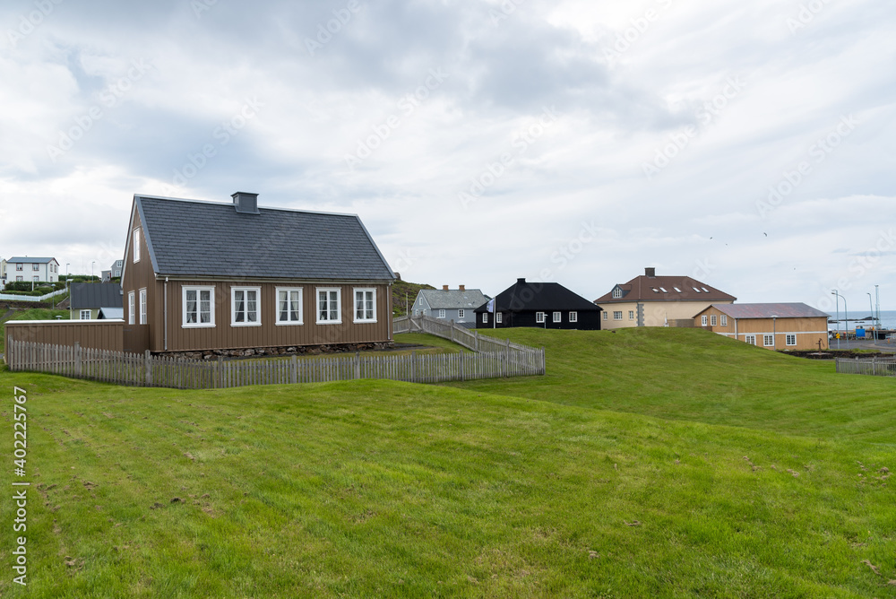 Traditional Icelandic houses in a coastal village on a cloudy summer evening. Stykkishólmur, Iceland.