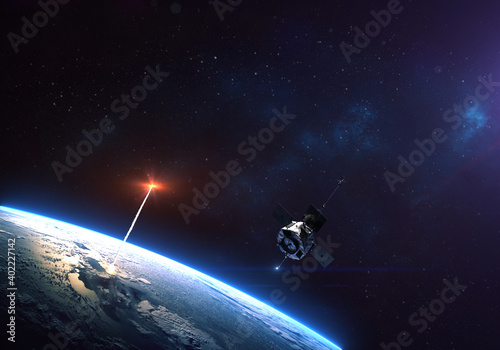 Fototapeta Naklejka Na Ścianę i Meble -  Rocket launch from the Earth planet through the clouds with a bright glow of the engine and a satellite on the orbit and a bright blue nebula galaxy. Elements of this image furnished by NASA