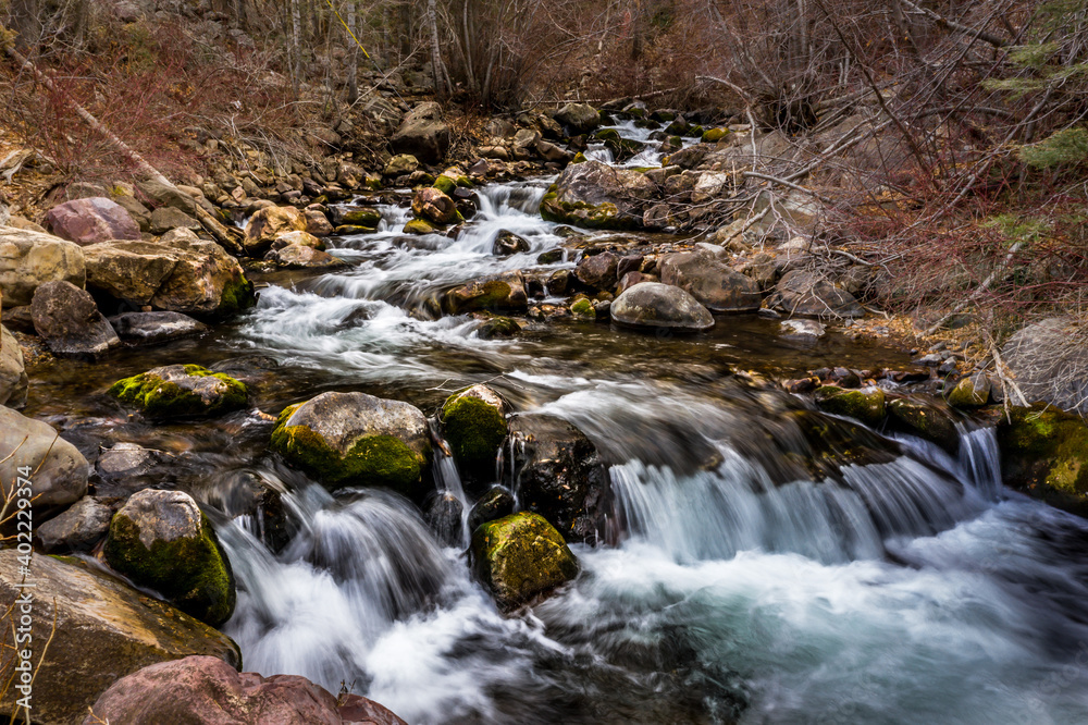 Fototapeta premium River Flowing Through the Mountains in the Winter Time