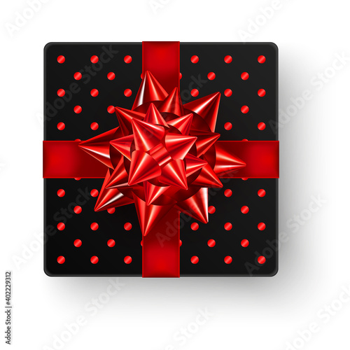 Black square gift box with big shiny red bow ribbon and glossy polka dot design, top view isolated on white background. Realistic vector illustration of Valentine, Christmas or birthday gift mockup