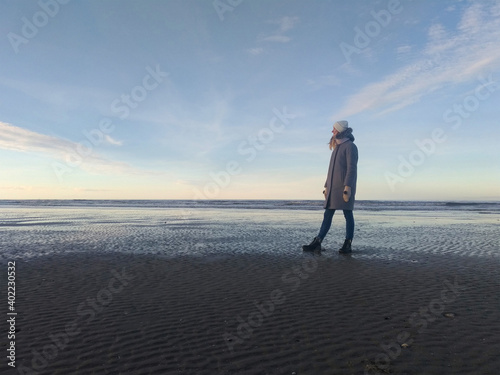 Girl on the background of the sea and blue sky coast of the English Channel in France in the city of Deauville. Travel across France. Woman traveler