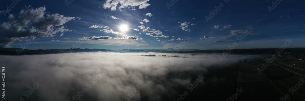 Fog starting to clear up, aerial above farmland