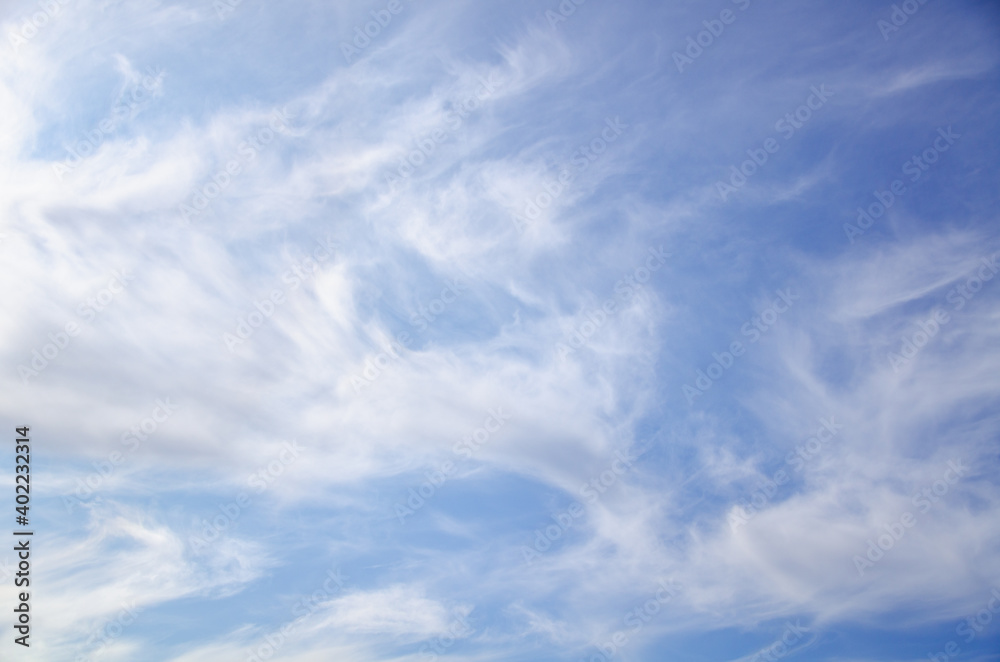 Blue sky background with abstract white clouds