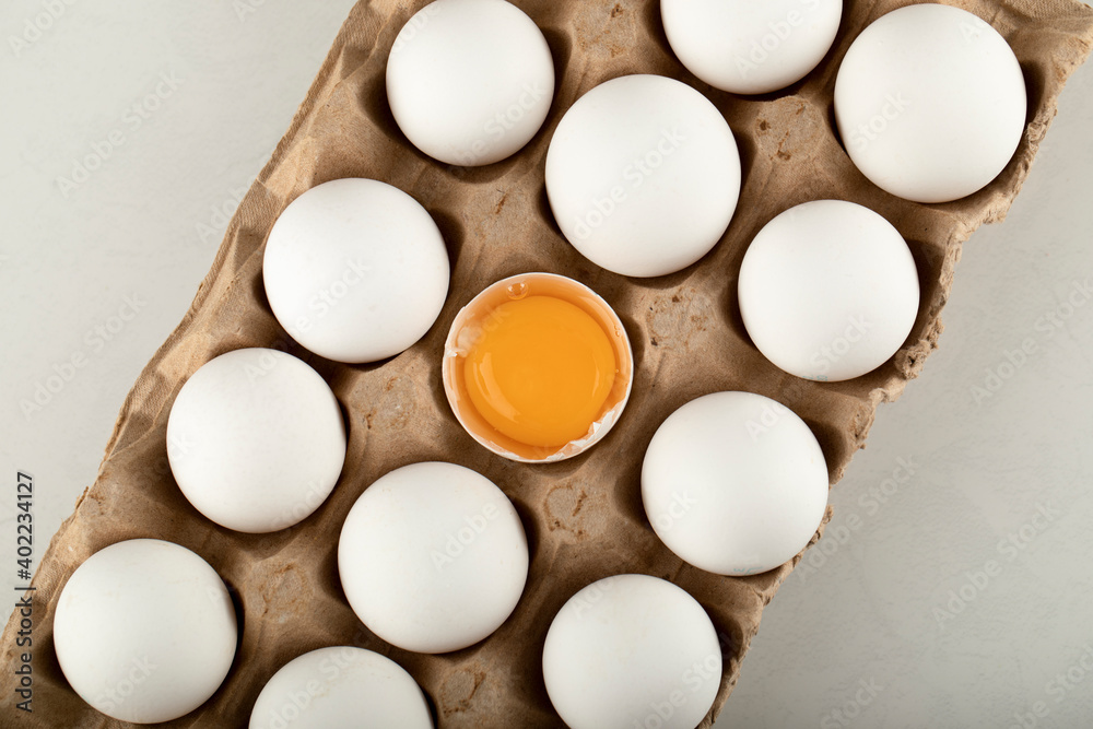 Raw chicken eggs in a carton container Raw chicken eggs in a carton container
