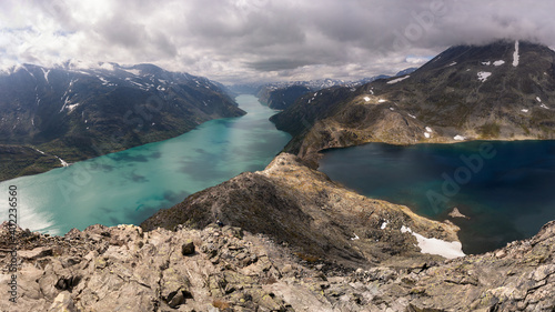 Amazing view of the Bessegen Ridge Panorama with the Gjende and Bessvatnet lake in a dramatic sky with dark clouds in the Jotunheimen National Park, Gjendesheim, Norway photo