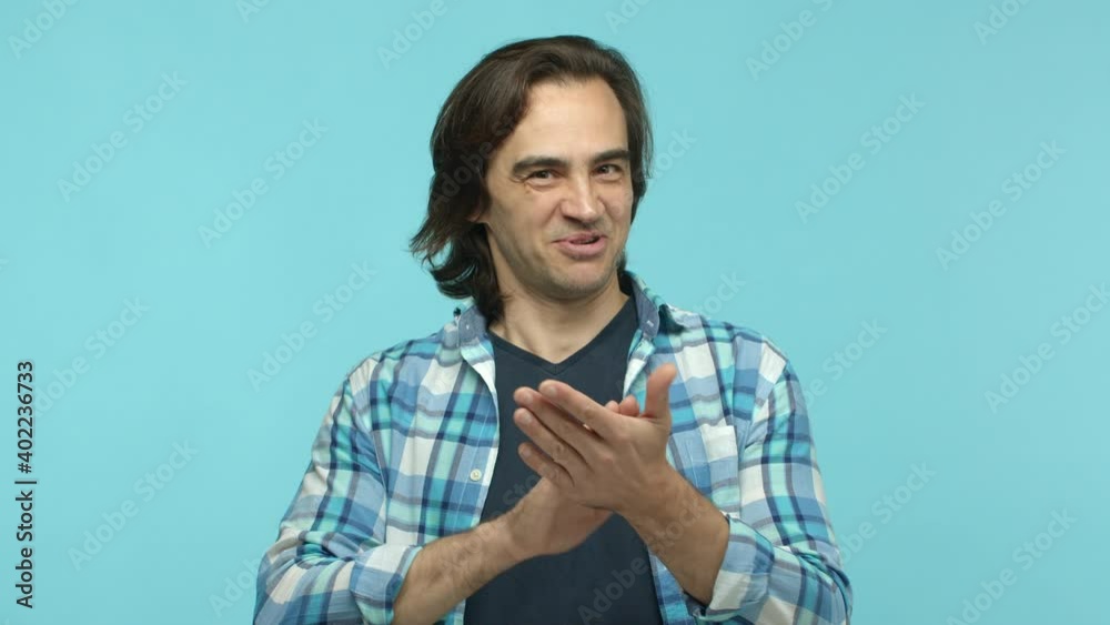 Slow motion of handsome middle aged man in casual clothes being proud and amazed, clap hands, applause and praise you, being amazed, standing over blue background Slow motion of handsome middle aged man in casual clothes being proud and amazed, clap hands, applause and praise you, being amazed, standing over blue background
