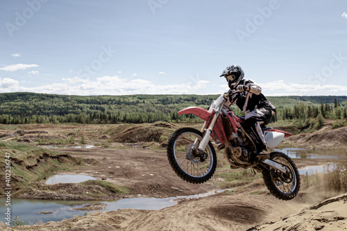 Fototapeta Naklejka Na Ścianę i Meble -  dirt bike motocross rider jump on the air Alberta sand dunes