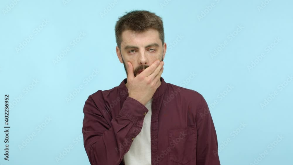 Annoyed and tired handsome man in casual outfit making facepalm, staring bothered and distressed, posing against blue background Annoyed and tired handsome man in casual outfit making facepalm, staring bothered and distressed, posing against blue background