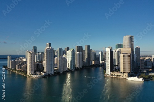 Fototapeta Naklejka Na Ścianę i Meble -  Miami, Florida - December 27, 2020 - Aerial view of City of Miami and entrance to Miami River on sunny winter morning.